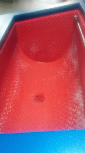 A close-up shot of the giant red vibratory tub